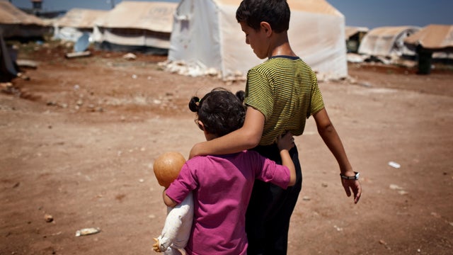 Syrian refugee children walk in the Bab al-Salam refugee camp in Syria's northern city of Azaz. 