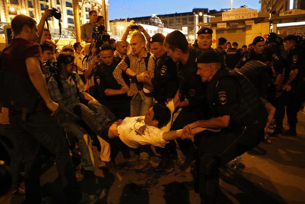 Police detain a protestor as people gather in support of opposition figure Alexei Navalny in the center of Moscow 