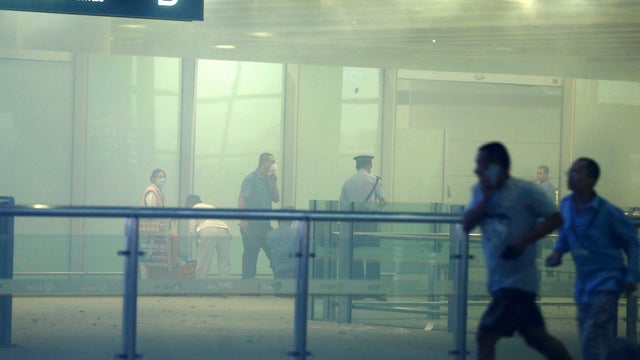 In this photo released by China's Xinhua News Agency, medical workers and policemen work at the terminal 3 of the Beijing International Airport in Beijing, Saturday, July 20, 2013.  