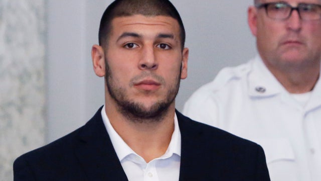 New England Patriots tight end Aaron Hernandez, left, stands with his attorney, Michael Fee, right, during a hearing in Attleboro District Court June 26, 2013, in Attleboro, Mass. 