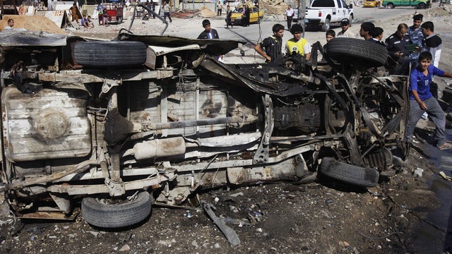 Iraqis inspect aftermath of car bomb attack in Shiite enclave of Sadr City, Baghdad, Iraq, Monday, July. 29, 2013. 
