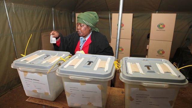 A woman casts her vote in presidential and parliamentary elections in Harare. 