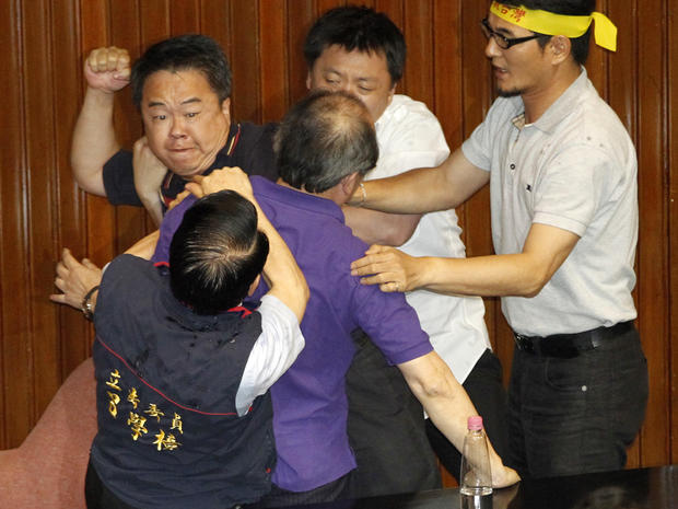 Ruling and opposition lawmakers fight on the legislature floor in Taipei, Taiwan, Aug. 2, 2013. 