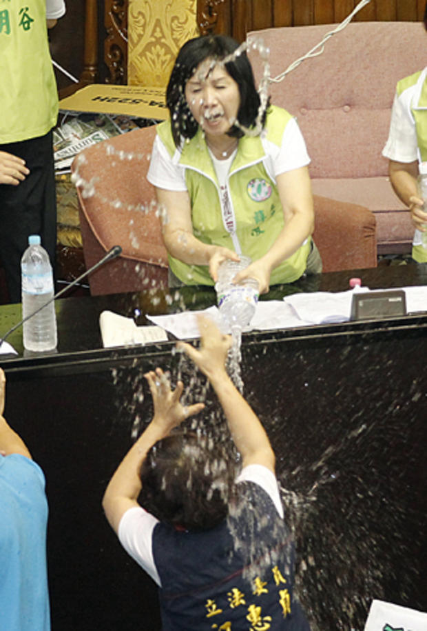 Ruling and opposition lawmakers fight with water on the legislature floor in Taipei, Taiwan, Aug. 2, 2013. 