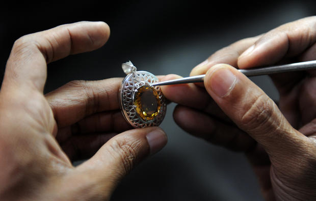 A Sri Lankan worker crafts silver jewell 