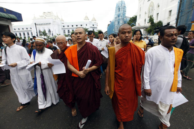 Burma Buddhist monks, Hindu, Muslim and Christian priests march to mark the 25th anniversary of Burma's pro-democracy uprising in Yangon, Burma. 