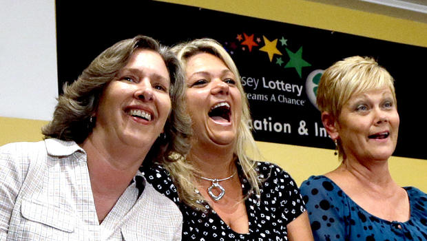 Lottery winners Lisa K. Presutto, left, Darlene M. Riccio, second left and Barbara Jo Riivald, third right, share a laugh as they listen to Lottery Director Carole Hedinger, right, executive director of the New Jersey lottery Tuesday, Aug. 13, 2013, in Toms River, N.J. 