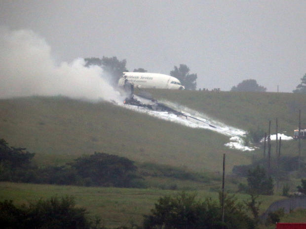 A UPS cargo plane lies on a hill at Birmingham-Shuttlesworth International Airport after crashing on approach Aug. 14, 2013, in Birmingham, Ala. 