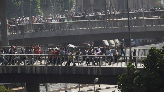 Supporters of ousted President Mohammed Morsi clash with other civilians while marching in Cairo 