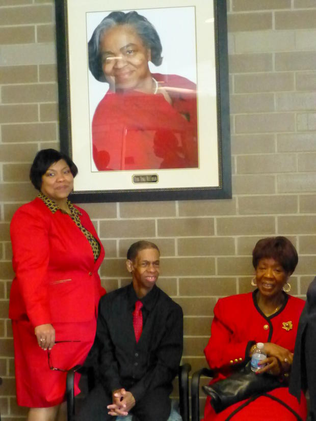 Loreen Banks-Kendricks and brother Edward below the photo of her late sister Diann Banks- Williamson for whom the new DPS special education facility is named.  8-20-13 