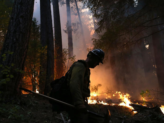 A firefighter from the Colorado-based Long Canyon Fire Department monitors a back fire while battling the Rim Fire Aug. 22, 2013, in Groveland, Calif., outside of Yosemite National Park. 