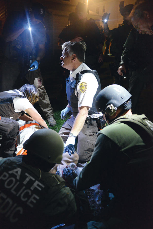 Medics rush to a wound Dzhokhar Tsarnaev at the conclusion of a manhunt on April 19, 2013. 