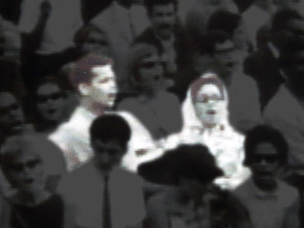 A young Julian Bond and a young Marian Wright sing "We Shall Overcome." 