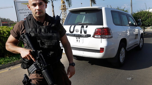 A Lebanese special forces policeman escorts the vehicles of U.N. experts upon their arrival at the private jet terminal at Beirut's international airport Aug. 31, 2013. 