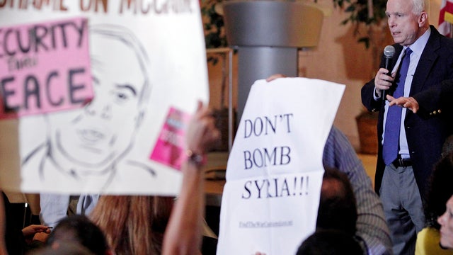 Sen. John McCain speaks over protesters during a town hall in Phoenix 