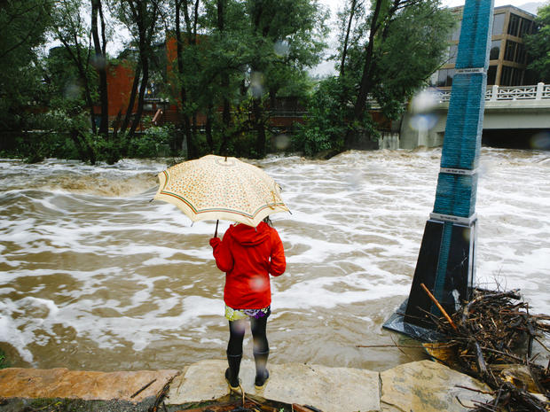 A woman looks at Boulder Creek, which flooded early Sept. 12, 2013, after three days of heavy rainfall in Boulder, Colo. 