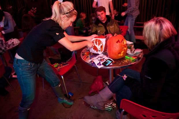 A woman carves a pumpkin at the 7th annu 