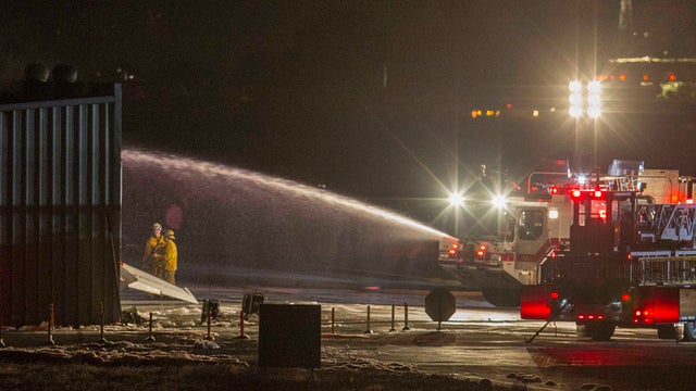 Firefighters work to extinguish fire at the site of a plane crash in Santa Monica 