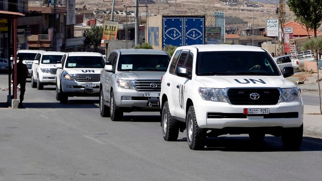 A convoy of inspectors from the Organization for the Prohibition of Chemical Weapons prepares to cross into Syria 