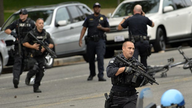 Police run at the corner of Constitution and 1st Street after shots fired were reported near 2nd Street NW and Constitution Avenue on Capitol Hill in Washington, DC, on October 3, 2013. The US Capitol was placed on security lockdown Thursday after shots w 
