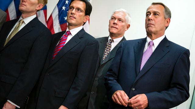 House Speaker John Boehner of Ohio, right, joined by members of the Republican Caucus, watches during a news conference on Capitol Hill in Washington Oct. 4, 2013. From left are, Rep. James Lankford, R-Okla., House Majority Leader Eric Cantor of Va., Rep. 