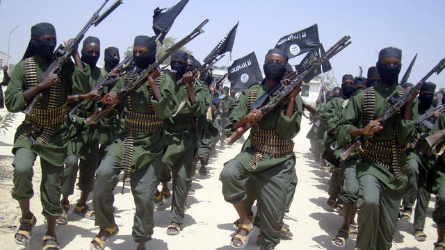 Al-Shabab fighters march with their weapons during military exercises on the outskirts of Mogadishu, Somalia, Feb. 17, 2011. 