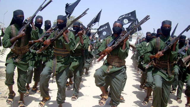 Al-Shabab fighters march with their weapons during military exercises on the outskirts of Mogadishu, Somalia, Feb. 17, 2011. 