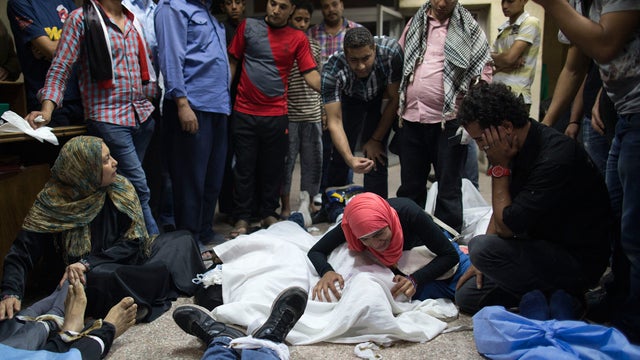  Supporters of Egypt's ousted President Mohammed Morsi mourn their relatives killed during clashes with security forces in Cairo, Egypt, Sunday, Oct. 6, 2013. Deadly clashes took place as rival crowds of supporters of the military and backers of Morsi pou 