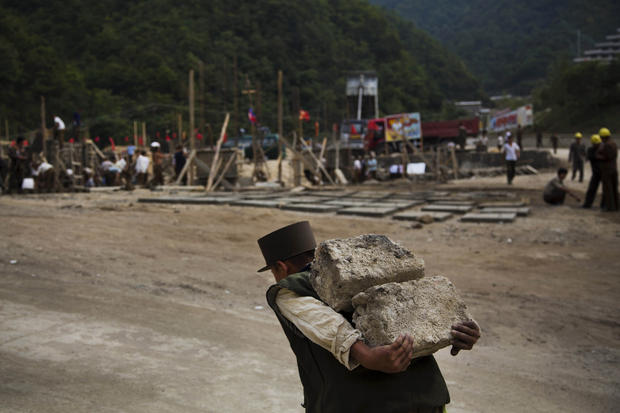 North Korean construction worker carries bricks at a building project to construct a ski resort at North Korea's Masik Pass. 