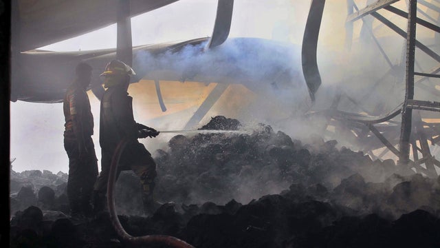 Bangladeshi firefighters douse a fire at a garment factory in Gazipur 