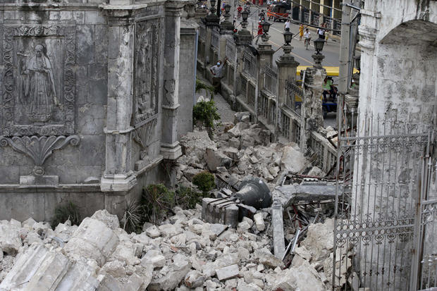 The bell of Basilica of the Holy Child lies amid the rubble following a 7.2-magnitude earthquake that hit Cebu city in central Philippines and toppled the bell tower of the Philippines' oldest church Tuesday, Oct. 15, 2013. 