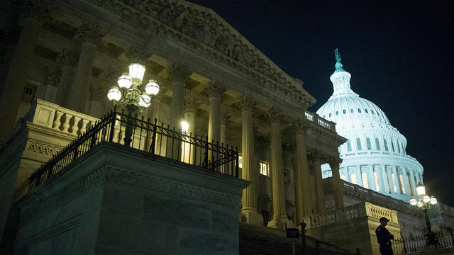 An officer stands on the steps of the House side of the Capitol building after a bipartisan bill passed by the House and the Senate reopened the government and raised the debt limit Oct. 16, 2013, in Washington. 