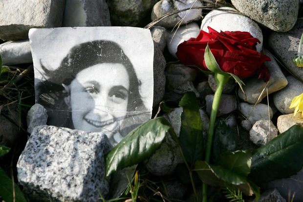A picture of Anne Frank lies in front of 