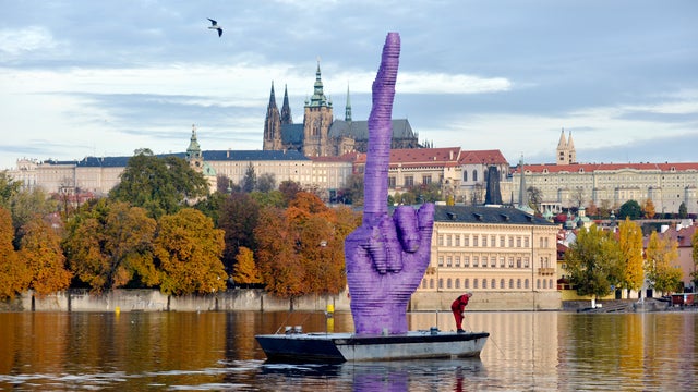 A 30-foot purple middle finger by sculptor David Cerny floats on the Vltava River in Prague 