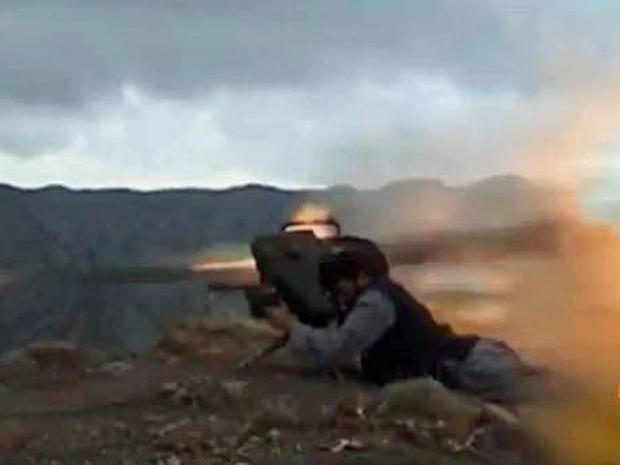 An militant from the Afghan Taliban launches a should-fired rocket 