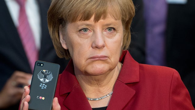 The March 5, 2013 file photo shows German Chancellor Angela Merkel presenting a tap-proof mobile phone of Blackberry. 
