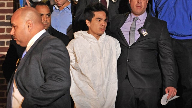 Mingdong Chen, a suspect in the murder of a five people in Brooklyn's Sunset Park neighborhood, is walked by police from the 66th precinct, Sunday, Oct. 27, 2013 in New York. The Chinese immigrant, who neighbors said struggled to survive in America, was a 