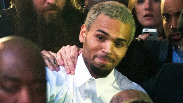 Singer Chris Brown, center, departs the H. Carl Moultriel courthouse Monday, Oct. 28, 2013, in Washington. 