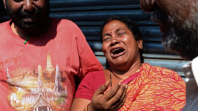 Relatives of passengers killed in bus crash/inferno react after getting word from police outside the private bus operator's office in Hyderabad, India on October 30, 2013 