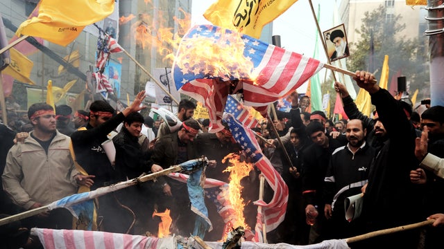 Iranians burn U.S. flags outside the former U.S. Embassy in Tehran 