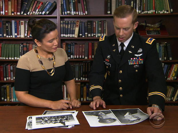 Army Maj.  Dwight Mears shows CBS News' Elaine Quijano photos of his grandfather, a U.S. airmen who was a POW in Switzerland. 