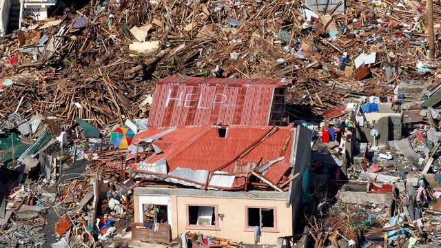 An aerial view shows signs for help and food amid the destruction left from Typhoon Haiyan in the coastal town of Tanawan, Philippines, Nov. 13, 2013. 