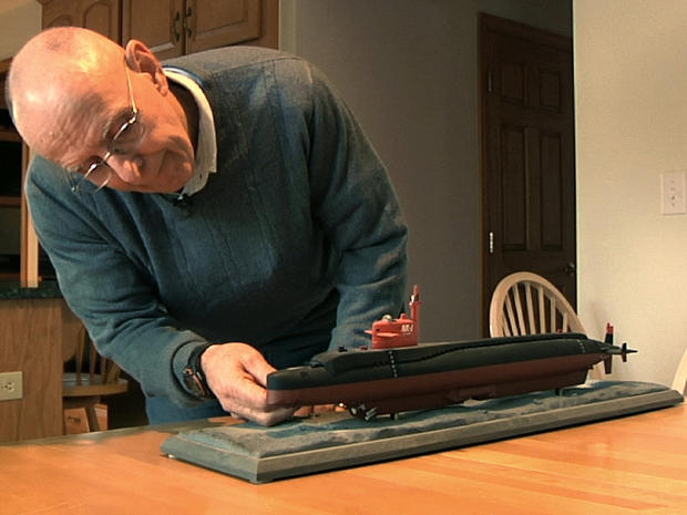 Michael Riegel, a former commander of the U.S. Navy submarine base in Groton, Conn., looks at a model of the research submarine NR-1 in his Preston, Conn., home Nov. 6, 2013. 