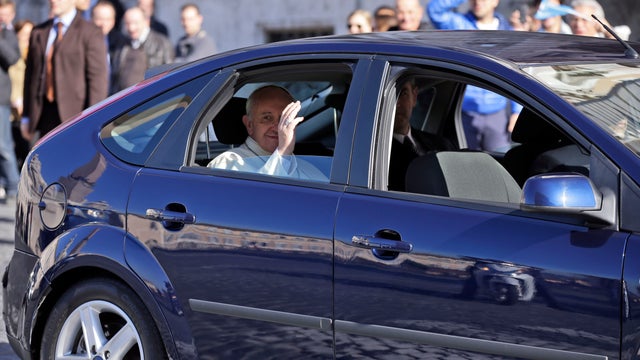 Pope Francis blesses the faithful from his Ford Focus 