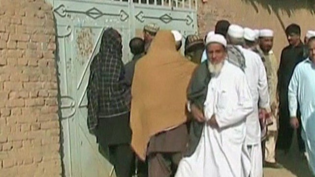 Pakistanis gather outside an Islamic seminary in Hangu district in Khyber Pakhtunkhwa province, Pakistan, after a drone strike on the compound 