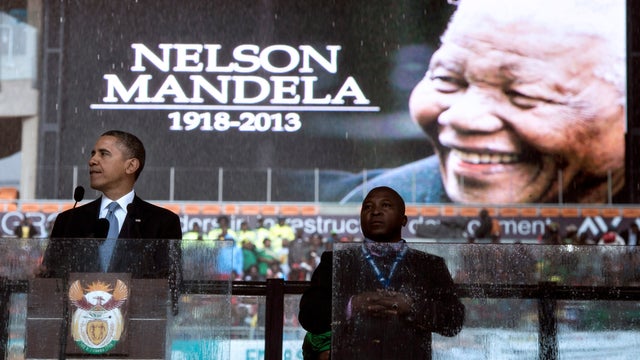President Obama pauses while speaking during the memorial service for late South African President Nelson Mandela 