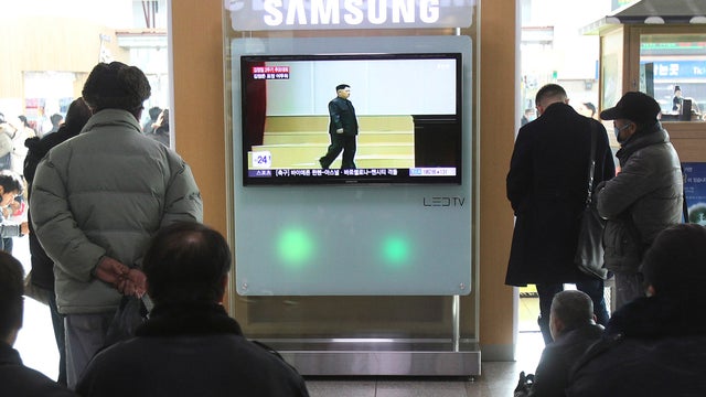 People watch a TV news program showing North Korean leader Kim Jong Un at the second anniversary of the death of his father, former leader Kim Jong Il, at the Seoul Railway Station 