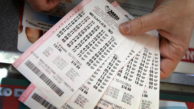 A customer holds a stack of Mega Millions lottery tickets which he purchased for his office pool at a convenience store Dec. 17, 2013, in Chicago. 