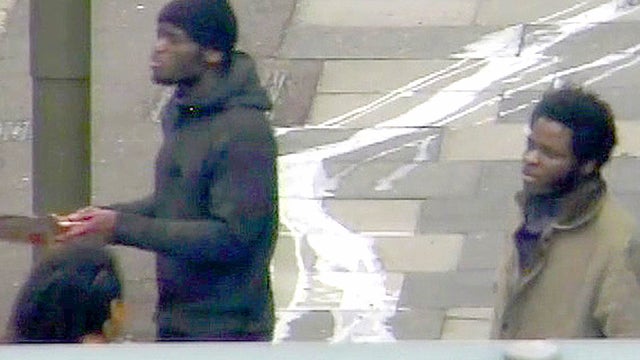 This photo made from CCTV and issued by the Metropolitan Police Dec. 19, 2013, shows Michael Adebolajo and Michael Adebowale May 22, 2013, speaking to a member of the public near the Woolwich Barracks in London. 