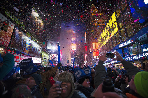 Revelers cheer under falling confetti at the stroke of midnight during the New Year's Eve celebrations in Times Square 